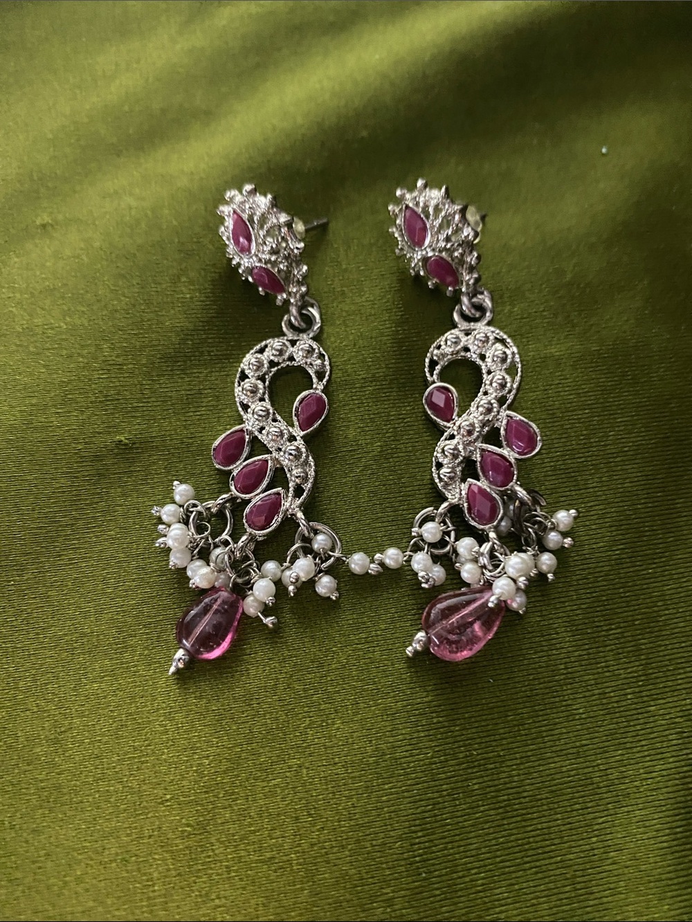 Silver colored earrings with magenta and pearl accents
